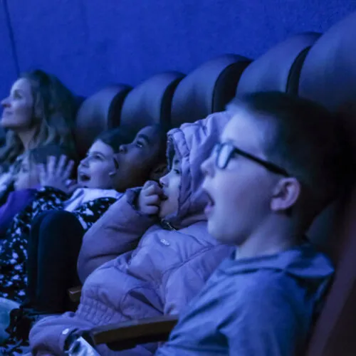 A group of people sitting in a theater