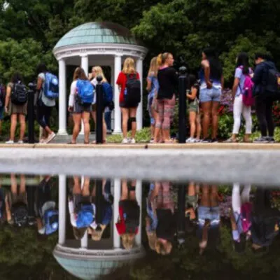 Students lining up in front of the Old Well